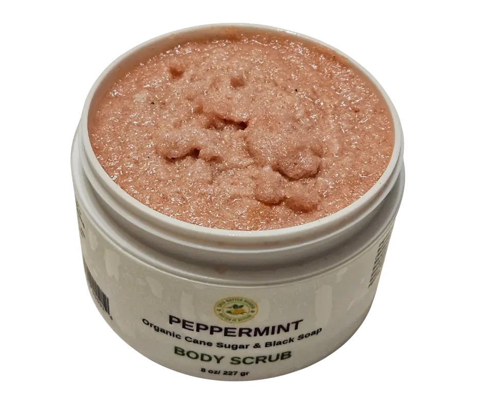 Open jar of peppermint emulsified sugar scrub with visible creamy texture and specks of black soap, showcasing its whipped consistency and refreshing minty green hue—ideal for exfoliating and moisturizing dry skin.