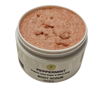 Open jar of peppermint emulsified sugar scrub with visible creamy texture and specks of black soap, showcasing its whipped consistency and refreshing minty green hue—ideal for exfoliating and moisturizing dry skin.