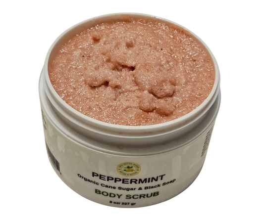 Open jar of peppermint emulsified sugar scrub with visible creamy texture and specks of black soap, showcasing its whipped consistency and refreshing minty green hue—ideal for exfoliating and moisturizing dry skin.