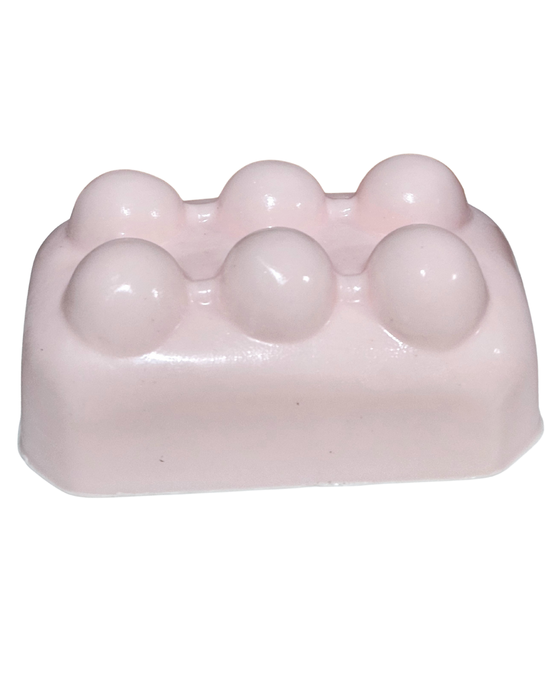 Pink soap bar with spherical lumps on a white background.“Pink Lemonade Mint Massage Soap Bar by Shea Butter Heaven – 4 oz exfoliating handmade soap