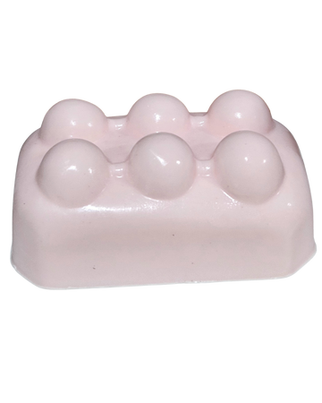 Pink soap bar with spherical lumps on a white background.“Pink Lemonade Mint Massage Soap Bar by Shea Butter Heaven – 4 oz exfoliating handmade soap