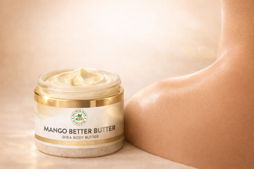 Open jar of Shea Butter Heaven Mango Better Butter showing smooth poured texture with glowing hydrated skin on a warm luxury background for body butter collection banner