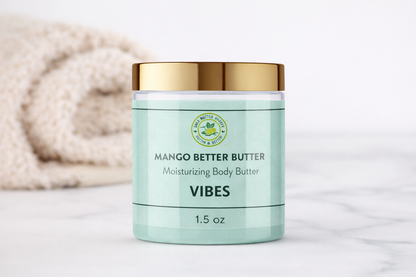 Shea Butter Heaven Mango Better Butter Vibes 1.5 oz mini moisturizing body butter jar displayed on a marble surface with folded towel in the background, lifestyle skincare setting