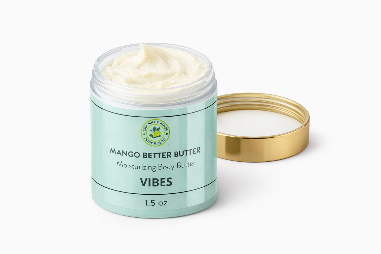 Open jar of Shea Butter Heaven Mango Better Butter Vibes 1.5 oz mini moisturizing body butter showing creamy texture with gold lid beside on a white background.